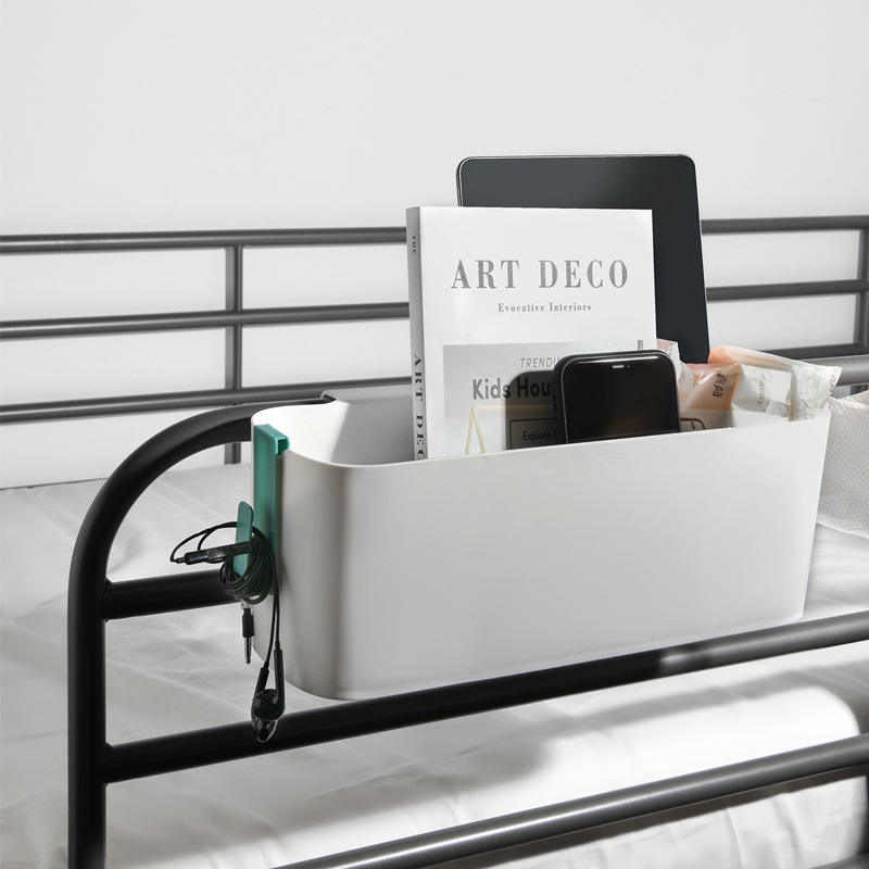 Bedside hanging basket holding books and electronics on dorm bed rail