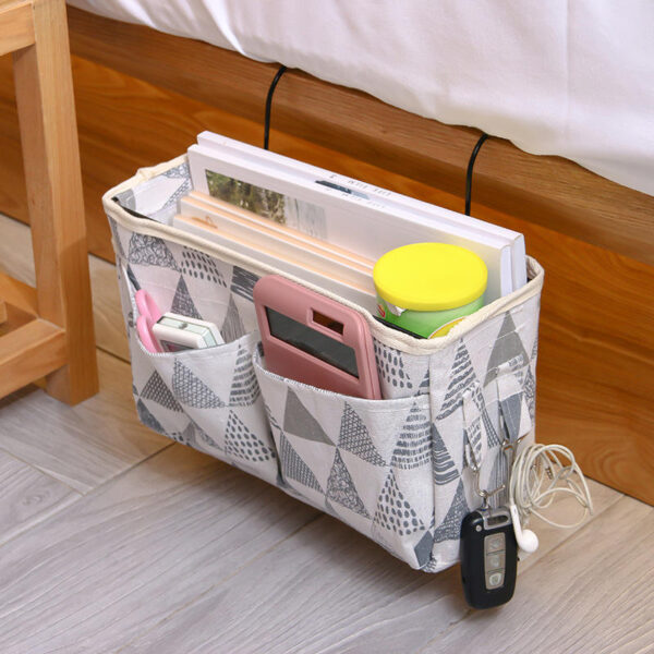 Multi-pocket bedside hanging bag holding books and daily essentials