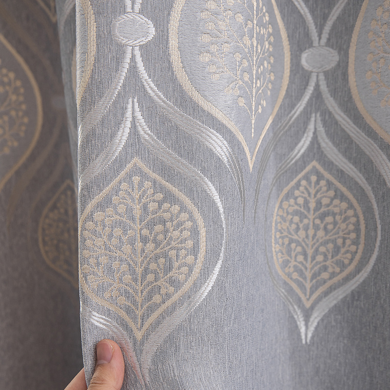 Close-up of waterproof grey curtain fabric, showing detailed gold pattern texture