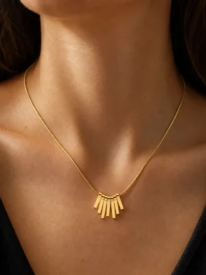 Model wearing water-resistant gold fan pendant necklace