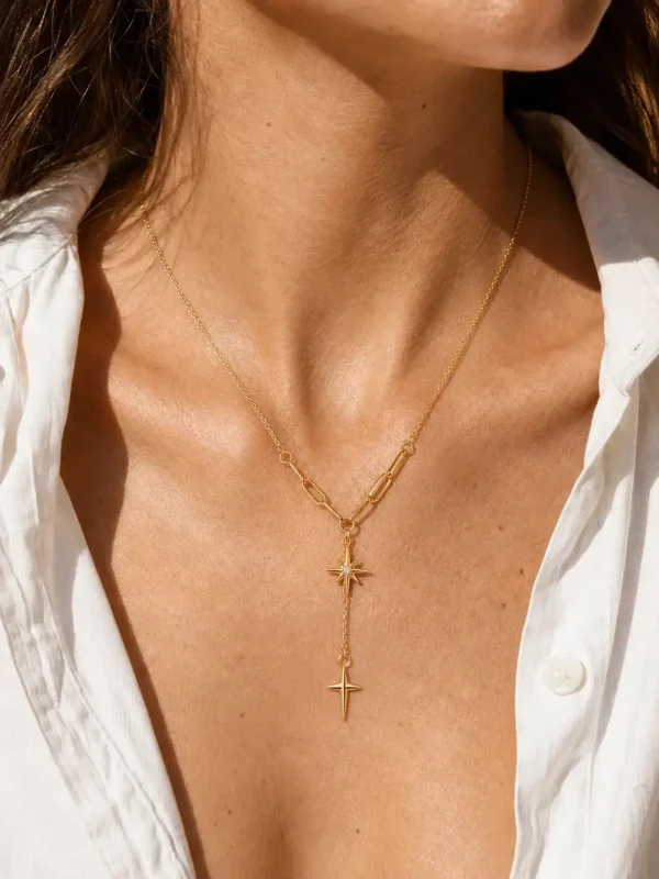 Water-resistant gold star drop necklace worn on neckline