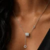 Silver-tone crystal drop pendant necklace worn on neckline