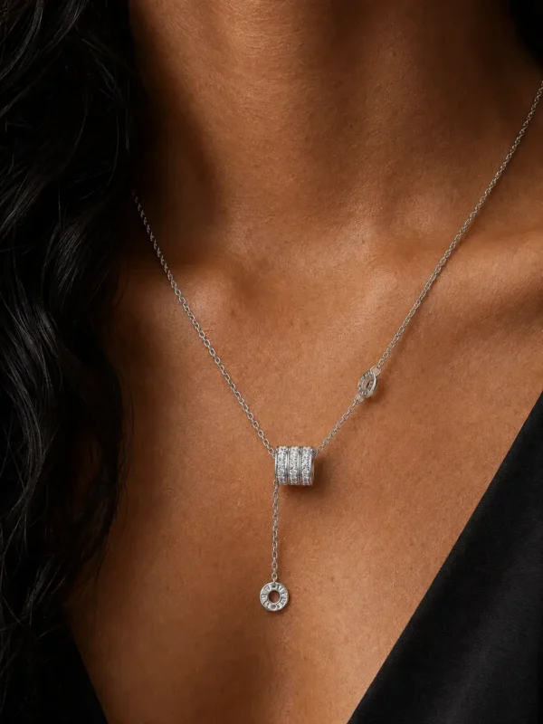 Silver-tone crystal drop pendant necklace worn on neckline