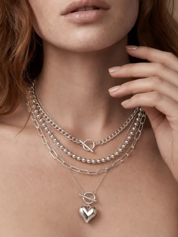 Model wearing silver layered toggle heart necklace