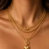 Model wearing gold layered toggle heart necklace
