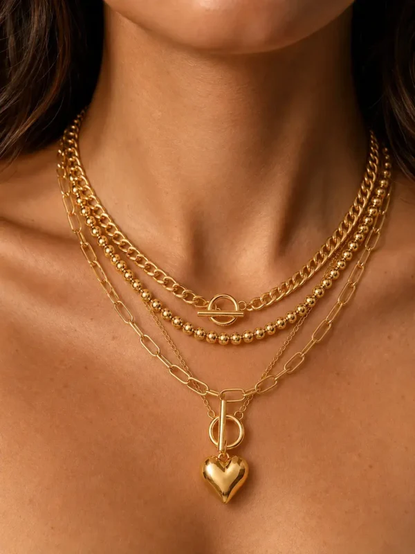 Model wearing gold layered toggle heart necklace