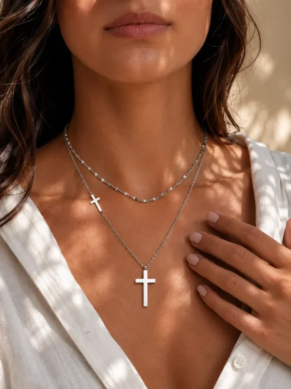 Water-resistant silver layered cross pendant necklace worn on model