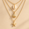 Gold layered shell starfish necklace with ocean charms