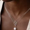 Model wearing silver geometric pearl pendant necklace