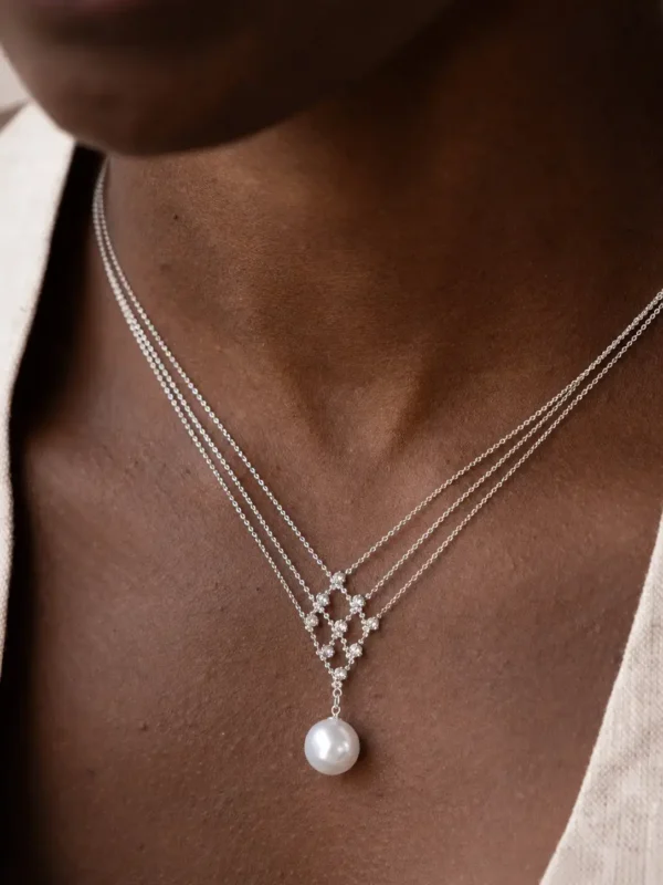 Model wearing silver geometric pearl pendant necklace