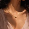 Model wearing gold layered bar chain necklace