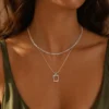 Model wearing silver layered rectangle pendant necklace set