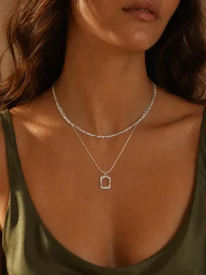 Model wearing silver layered rectangle pendant necklace set