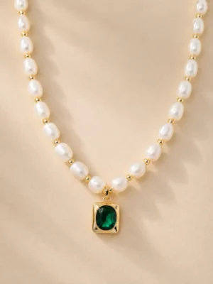 Freshwater pearl necklace with green stone pendant close up